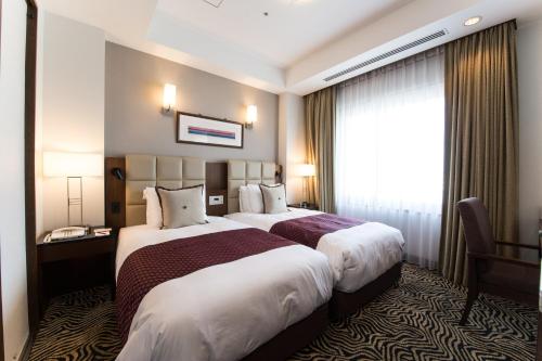 Säng eller sängar i ett rum på ANA Crowne Plaza Yonago, an IHG Hotel