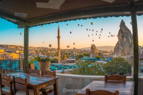 a view of a city with hot air balloons in the sky at Goreme House in Goreme