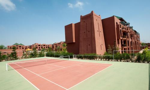 a tennis court in front of a building at Palm Plaza Marrakech in Marrakech