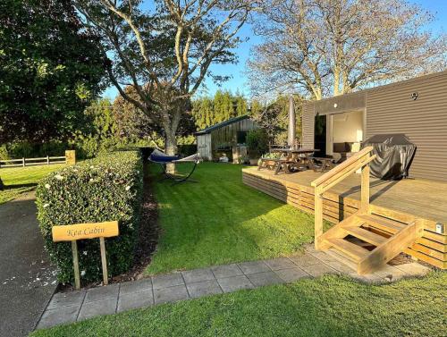 a backyard with a wooden bench and a table at Heaven's Rest B&B in Pukekohe East