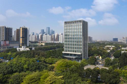 a tall building in the middle of a city at DoubleTree By Hilton Shenzhen Nanshan Hotel & Residences in Shenzhen