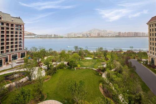 an aerial view of a park next to a body of water at Doubletree By Hilton Qingdao Oriental Movie Metropolis in Huangdao