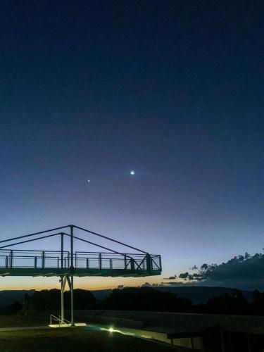 a view of a bridge at night with the moon at Pousada Mirante Dos Adelphos in Socorro