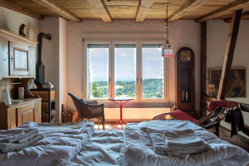 a bedroom with a large bed and a window at Retreat Lodge Schürmatt -Leben wie SchweizerInnen in Günsberg  
