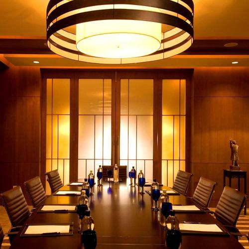 a conference room with tables and chairs and a chandelier at Hilton Beijing - Close to Capital Airport Express Subway & Liangma River located in the Embassy area in Beijing