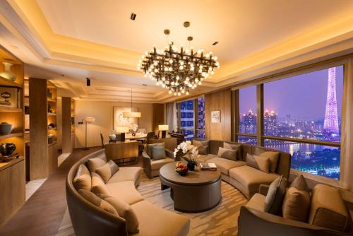 a living room with couches and a chandelier at Conrad Guangzhou - Free shuttle between hotel and Exhibition Center during Canton Fair & Exhibitor registration Counter in Guangzhou