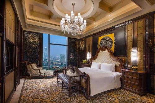 a bedroom with a bed and a chandelier at Hilton Changzhou in Changzhou