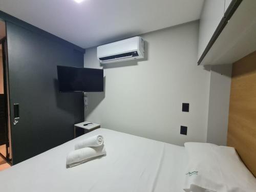 a hospital room with a bed and a air conditioner at Get One - Bessa in Tambaú