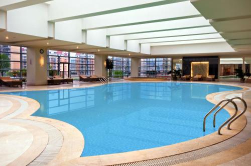 a large swimming pool in a hotel lobby at Hilton Hefei in Hefei