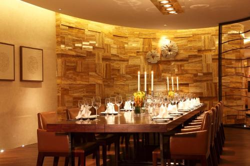 a long table in a room with a wooden wall at DoubleTree by Hilton Hangzhou East in Hangzhou