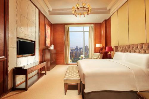 杭州市にあるダブルツリー バイ ヒルトン 杭州 イーストのベッドとテレビが備わるホテルルームです。