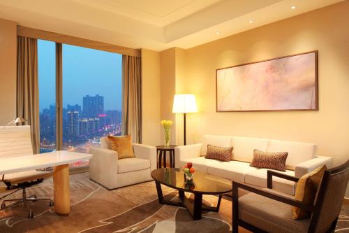 a living room with a grand piano and a living room with a living room at DoubleTree by Hilton Hangzhou East in Hangzhou