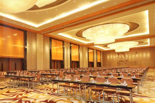 a large room with tables and chairs in it at DoubleTree by Hilton Hangzhou East in Hangzhou