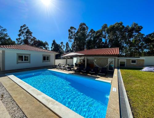 a swimming pool in the backyard of a house at Casa Real - Royal Villa in Esposende