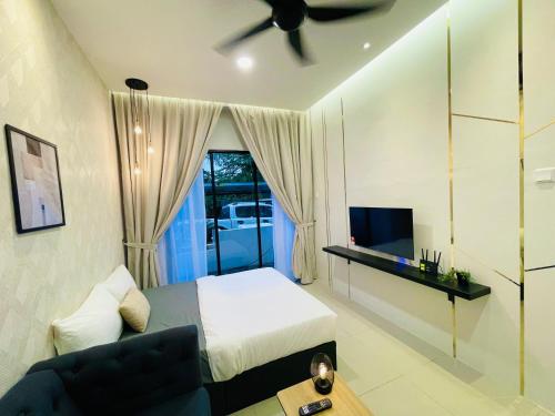 a bedroom with a bed and a couch and a tv at The Cove Duplex 13pax 3Br 4bathroom 2parking by IWH Suites in Ipoh