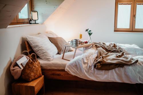 a bedroom with a bed with a table on it at Nebesky 81 in Kunčice pod Ondřejníkem