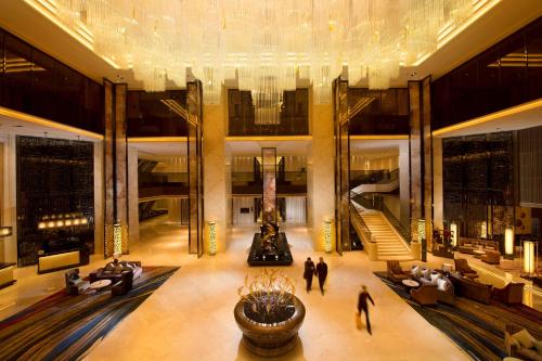 a lobby with people walking in a building at Hilton Zhongshan Downtown in Zhongshan