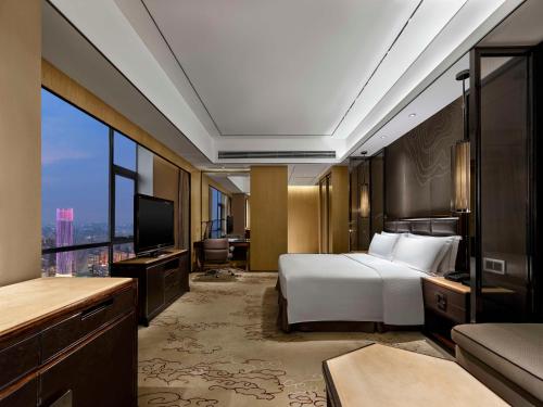 Ένα ή περισσότερα κρεβάτια σε δωμάτιο στο Hilton Zhongshan Downtown
