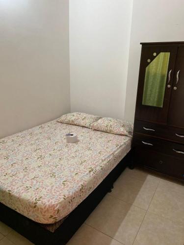 Dormitorio pequeño con cama y vestidor en Hostal en la 17 en Socorro