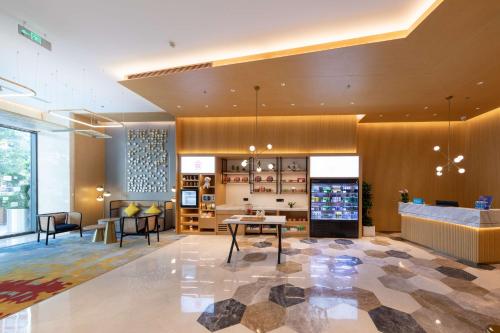 a lobby of a store with a table and chairs at Hilton Garden Inn Shenzhen Nanshan Avenue in Shenzhen