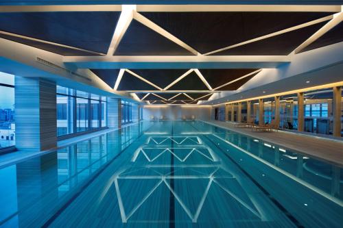 - une grande piscine dans un bâtiment dans l'établissement DoubleTree By Hilton Wuxi, à Wuxi