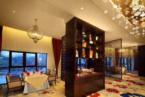a dining room with a table and a chandelier at DoubleTree by Hilton Hotel Putian in Putian