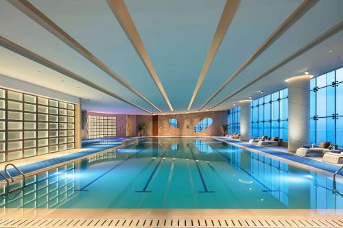 a large swimming pool in a building at Hilton Yantai in Yantai