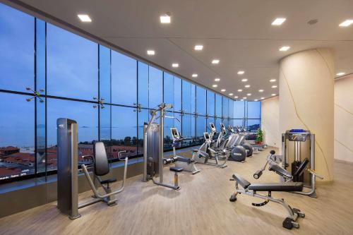 a gym with treadmills and cardio equipment in a building at Hilton Yantai in Yantai