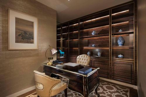 a home office with a desk and two chairs at Hilton Yantai in Yantai
