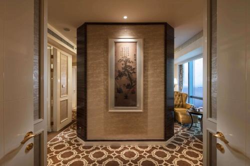 a hallway with a wall with a painting on it at Hilton Yantai in Yantai