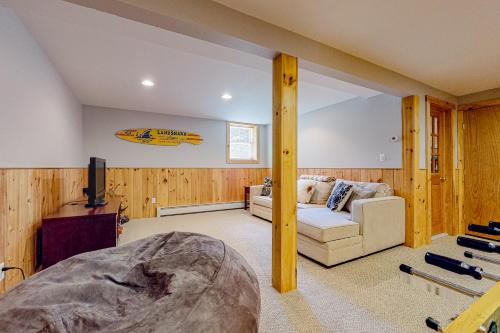 a living room with a couch and a tv at Beaver Glen in Vermont Ventures