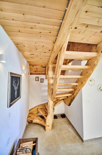 a staircase in a house with wooden ceilings at MoMa Escape in Borje