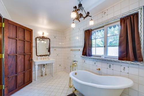 een badkamer met een groot bad en een wastafel bij Missouri Castle with Private Lake, Pool and 100 Acres! in Avon