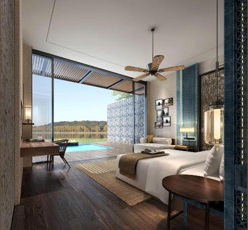 um quarto com uma cama grande e uma piscina em Doubletree Resort By Hilton Hainan - Xinglong Lakeside em Wanning