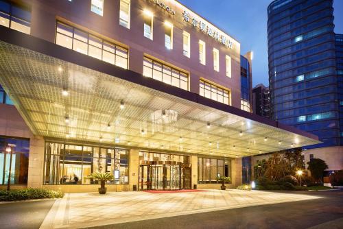 a large building with a lot of windows at DoubleTree By Hilton Ningbo Beilun in Ningbo