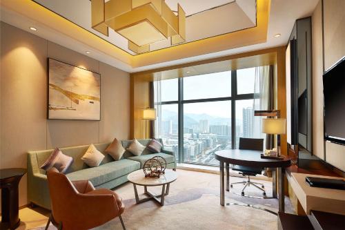 a living room with a couch and a table at DoubleTree By Hilton Ningbo Beilun in Ningbo