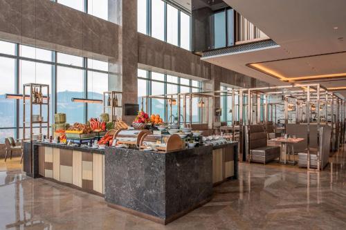 a lobby of a hotel with a buffet at Hilton Jinan South Hotel & Residences in Jinan