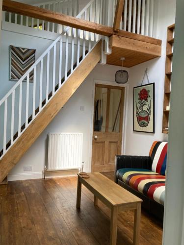 a living room with a staircase and a couch at The Vineyard in Portsmouth