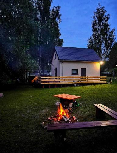 a fire pit in a yard in front of a house at SapinaChillout in Pozezdrze