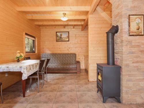 a living room with a stove and a table with chairs at Holiday Resort in Pobierowo for 6 persons in Pobierowo