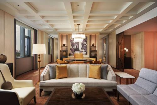 a living room with a couch and a table at Conrad Tianjin in Tianjin