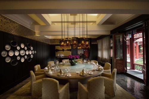a dining room with a round table and chairs at Waldorf Astoria Beijing in Beijing