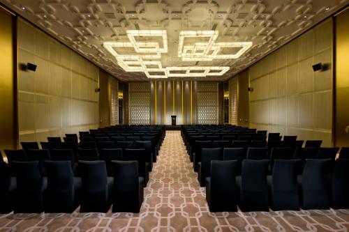 an empty hall with chairs and a podium in the middle at Waldorf Astoria Beijing in Beijing
