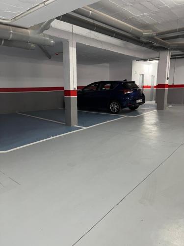 a car parked inside of a parking garage at SHERRY SUÍTES III Apartamentos PARKING GRATUITO in Jerez de la Frontera