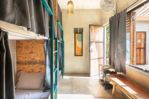 a bedroom with a bunk bed in a room at Hostal Doña Lucha in Tulum
