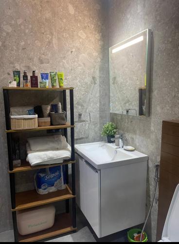 a bathroom with a sink and a mirror at Appartement mehdia en face de la plage in Kenitra