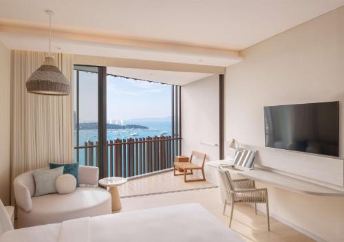 a living room with a view of the ocean at Hilton Pattaya in Pattaya Central