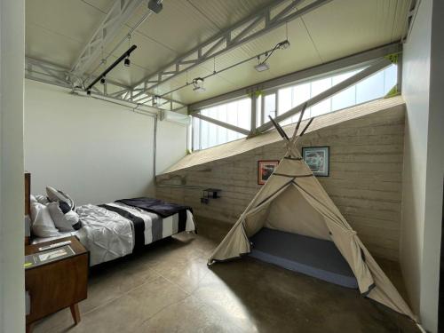 a bedroom with a tent in the middle of a room at Luxury Villa Cañadas in Guadalajara