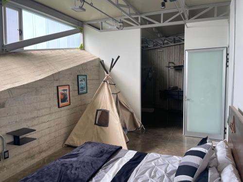 a room with a bed and a tent in it at Luxury Villa Cañadas in Guadalajara