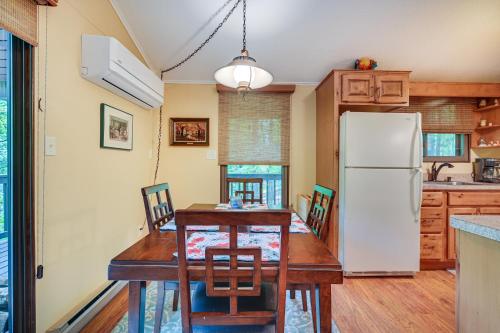 a kitchen with a table and a refrigerator at Charming Hedgesville Retreat with Deck and Fireplace! in Hedgesville